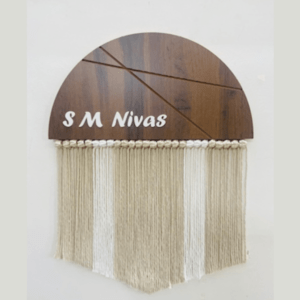 Our Macramé 3D Wooden Name Plate is a stunning and personalized addition to your home décor. Crafted with care, this wooden name plate features a mesmerizing macramé 3D design that adds depth and dimension to your space. The names are customized using high-quality 4mm acrylic, creating a sleek and modern look. Whether you want to showcase your family name, individual names, or special phrases, this name plate is a unique and eye-catching way to personalize your living spaces. Hang it on your front door, in your bedroom, or use it as a statement piece in any room. The Macramé 3D Wooden Name Plate with 4mm acrylic names is a perfect choice for adding a personalized touch and elevating the aesthetic appeal of your home.